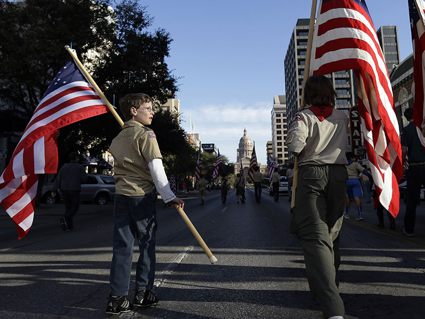 Boy Scouts carry U.S. flags up Congress Avenue towards the Texas Capitol during the annual Boy Scouts Parade and Report to State, Saturday, Feb. 2, 2013, in Austin, Texas. (Photo Eric Gay/AP)