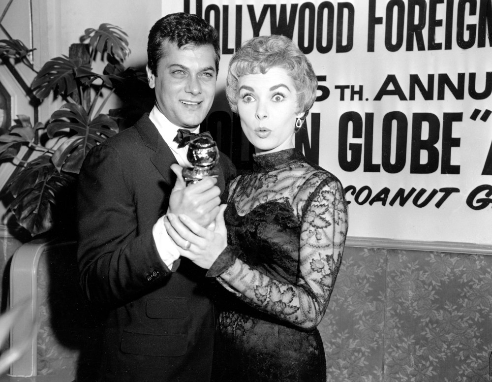 Tony Curtis holds his Golden Globe award for World Male Film Favorite as his wife, actress Janet Leigh, gives a look of surprise at the Hollywood Foreign Press Association awards dinner at the Coconut Grove in Hollywood, Calif., Feb. 26, 1958. Curtis...