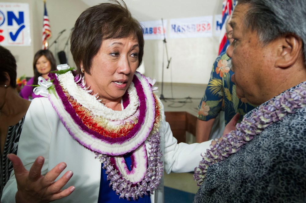 U.S. Rep. Colleen Hanabusa, Democrat, from Hawaii's 1st district, talks to former Hawaii Governor Ben Cayetano, right, at her campaign headquarters, Aug. 9, 2014, in Honolulu, Hawaii.