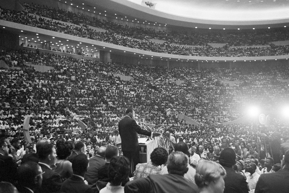 Rev. Martin Luther King Jr., speaks to an overflow crowd in Detroit's Cobo Hall Arena on Sunday, June 24, 1963, following a Freedom March. (AP Photo)