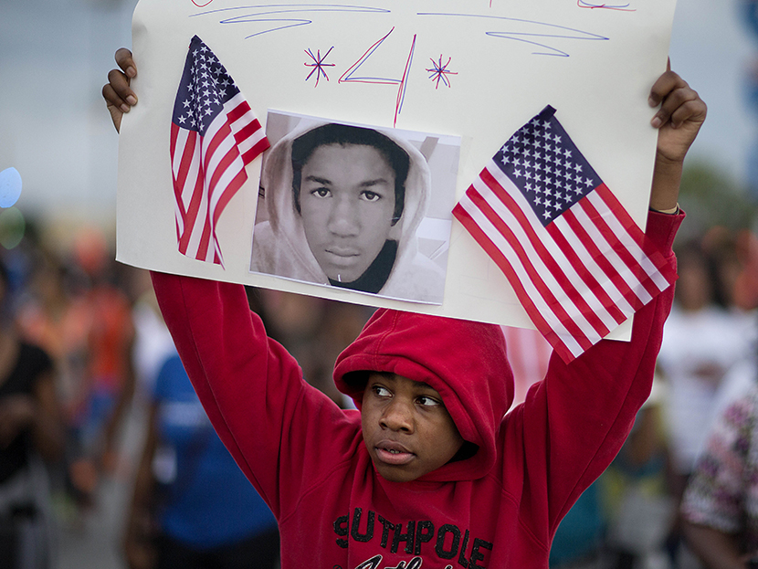 Jaylen Reese, 12, of Atlanta, marches to downtown during a protest of George Zimmerman's not guilty verdict in the 2012 shooting death of teenager Trayvon Martin, Monday, July 15, 2013, in Atlanta. (Photo by David Goldman/AP)