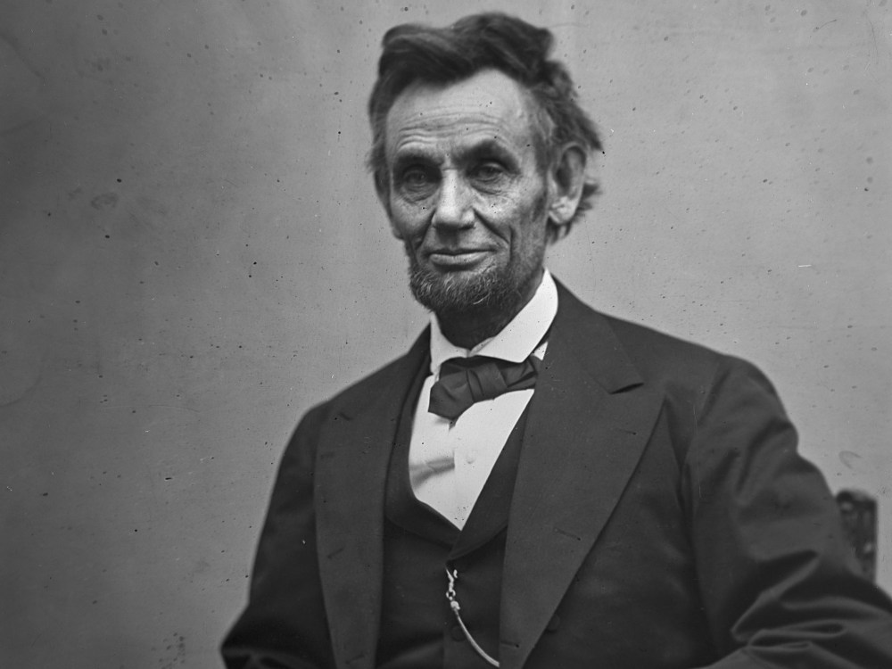 File Photo: In this photo provided by the Library of Congress, President Abraham Lincoln, seated and holding his spectacles and a pencil on Feb. 5, 1865. (Photo by Alexander Gardner/AP Photo/Library of Congress, File)