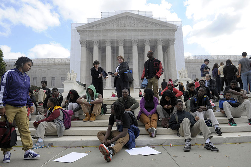 People supporting the University of Texas rally outside the Supreme Court in Washington, Wednesday, Oct. 10, 2012. The Supreme Court is taking up a challenge to a University of Texas program that considers race in some college admissions. The case...