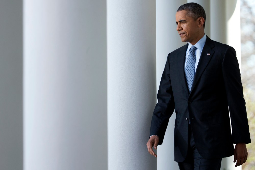 President Barack Obama walks from the Oval Office to the Rose Garden of the White House in Washington, April 1, 2014.