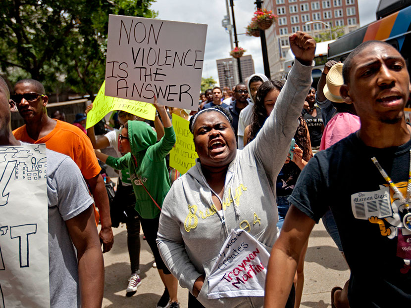 Lisa Archer, 24, of Atlanta, center, chants as protestors march, Sunday, July 14, 2013, in Atlanta the day after George Zimmerman was found not guilty in the 2012 shooting death of teenager Trayvon Martin.   (Photo by David Goldman/AP)