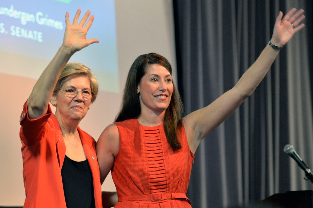 Democratic U.S. Sen. Elizabeth Warren, left, of Massachusetts and Kentucky democratic Senatorial candidate Alison Lundergan Grimes wave to supporters at at rally on Sunday, June 29, 2014 at the University of Louisville in Louisville, Ky.