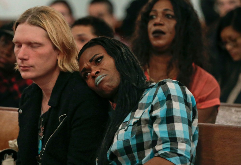 A couple attending a Trans Day of Remembrance program listen during a speech about violence against transgender people, in New York, Nov. 18, 2015. (Photo by Julie Jacobson/AP)