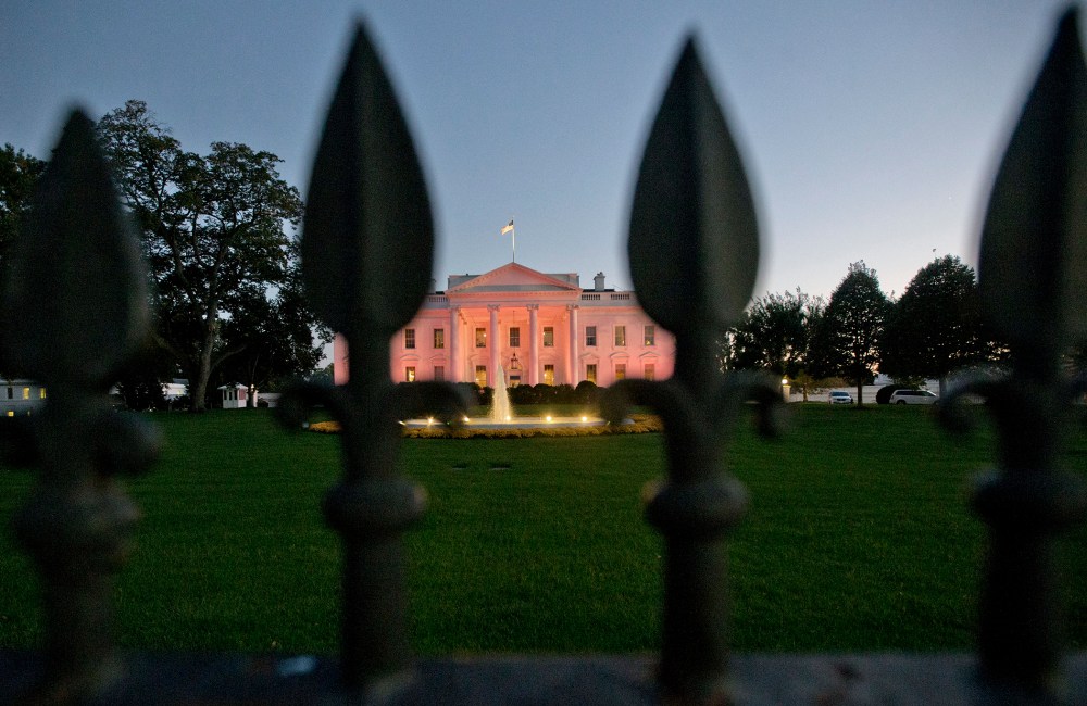 The White House in Washington is bathed in pink light on Oct. 24, 2013.