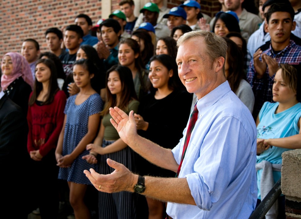California Prop. 39 co-chair Tom Steyer takes photos with students at John Marshall High School in Los Angeles, Oct. 28, 2014. (Photo by Damian Dovarganes/AP)