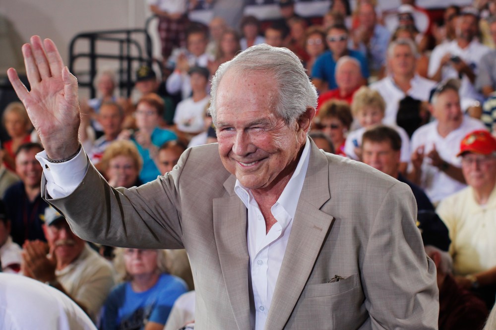 Evangelist Pat Robertson waves at the crowd during a campaign rally for Mitt Romney at the Military Aviation Museum in Virginia Beach, Va., Sept. 8, 2012.