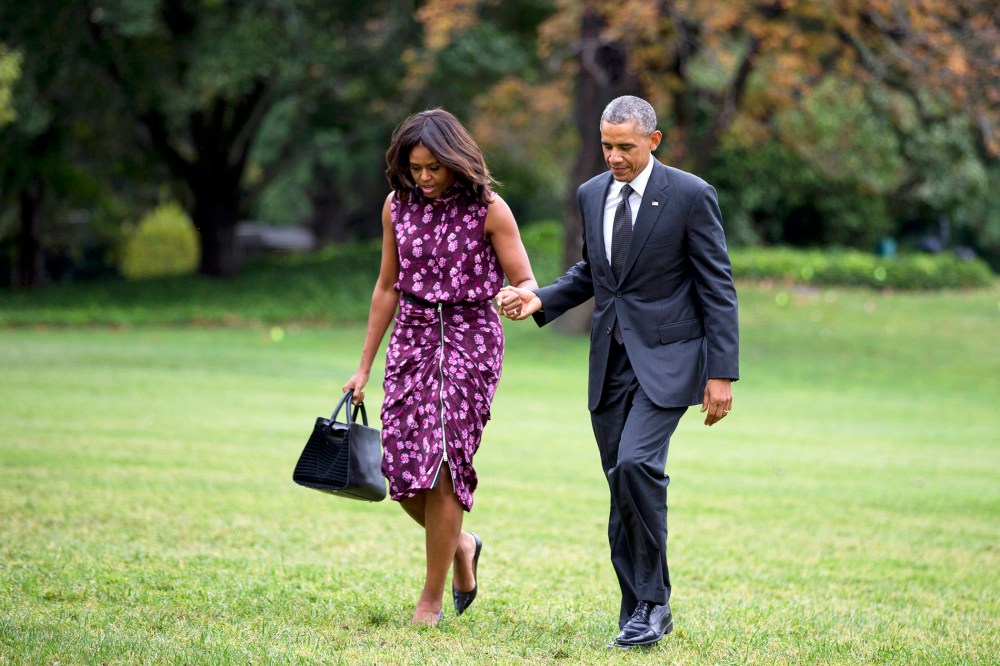 President Barack Obama and first lady Michelle Obama walk on the South Lawn of the White House in Washington, D.C., Sept. 25, 2014. (Photo by Manuel Balce Ceneta/AP)