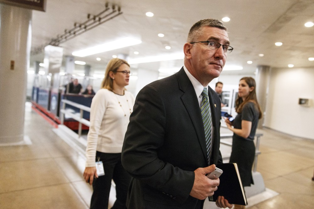 Sen. John Walsh walks to the Senate chamber on Capitol Hill in Washington, Feb. 12, 2014.