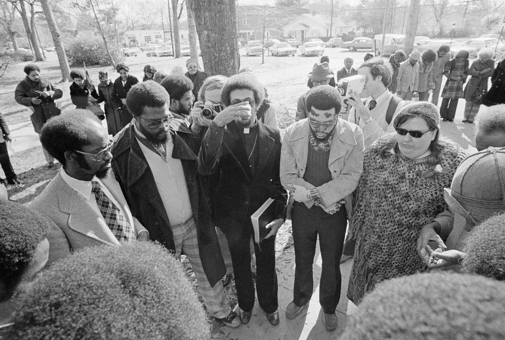 Members of the Wilmington 10 hold a brief communion service before boarding a prison bus on Feb. 2, 1976 in Burgaw, North Carolina, as they surrendered to start prison terms on convictions growing out of 1971 racial disorders in Wilmington, N.C. (AP...