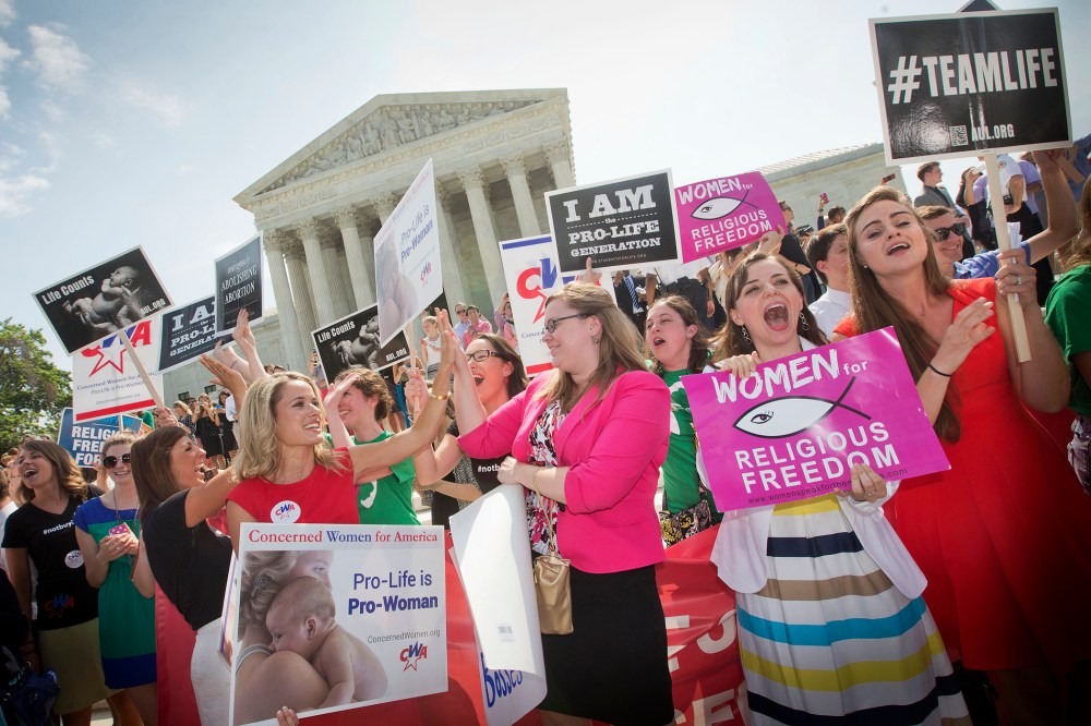 Demonstrators react to hearing the Supreme Court's decision on the Hobby Lobby case outside the Supreme Court in Washington, D.C., June 30, 2014.