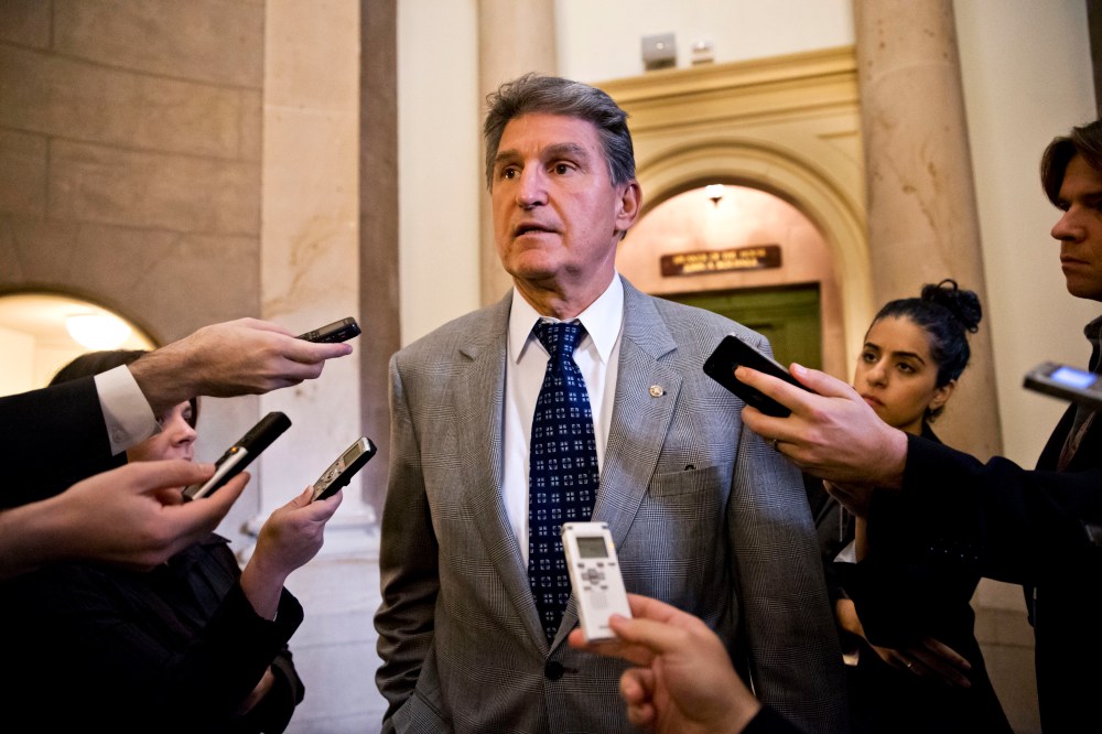 Sen. Joe Manchin, D-W.Va., is questioned for updates by reporters at the Capitol in Washington, Monday, Oct. 14, 2013, as a partial government shutdown enters its third week.