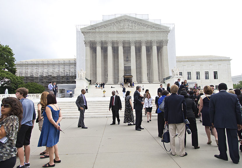 People wait outside the Supreme Court in anticipation of key decisions being announced, on Capitol Hill in Washington, Monday, June 17, 2013. (Photo by J. Scott Applewhite/AP)