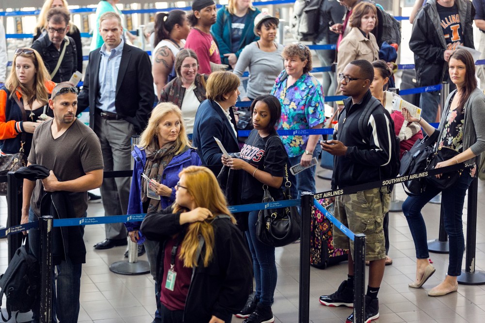 Travelers in line at Los Angeles International airport Monday, April 22, 2013. (AP Photo/Damian Dovarganes)