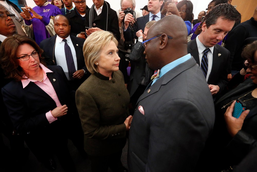 Democratic presidential candidate Hillary Clinton speaks with an audience member at the House Of Prayer Missionary Baptist Church, Feb. 7, 2016 in Flint, Mich. (Photo by Paul Sancya/AP)