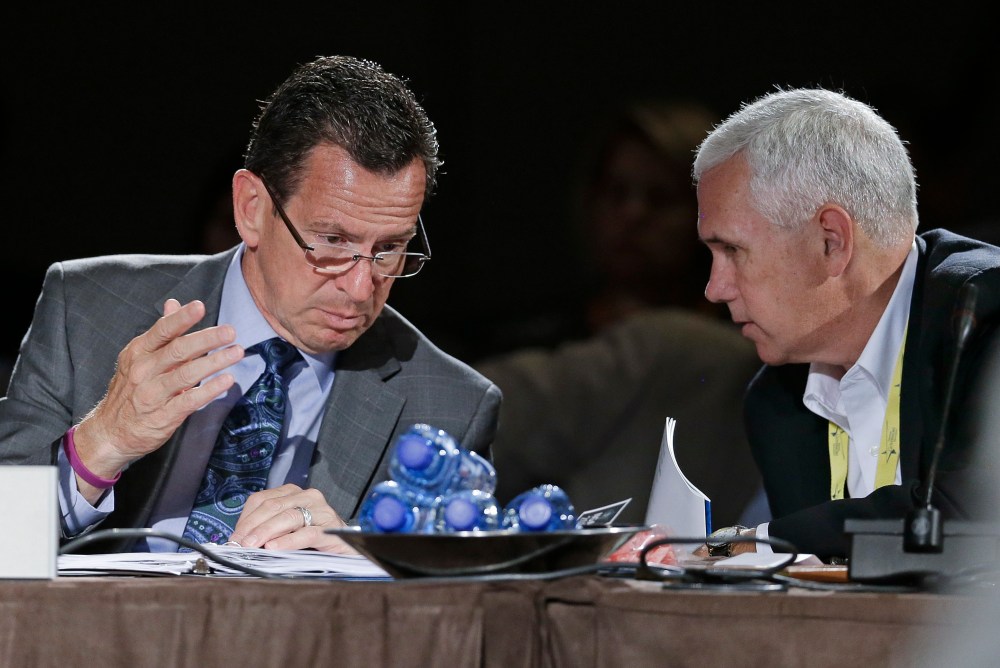 Connecticut Gov. Dan Malloy talks with Indiana Gov. Mike Pence during a meeting on jobs and education at the National Governors Association convention on July 12, 2014, in Nashville, Tenn. (Photo by Mark Humphrey/AP)