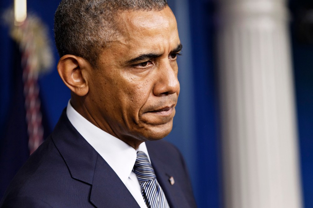 President Barack Obama pauses while speaking in the Brady Press Briefing Room of the White House on July 18, 2014 in Washington, D.C. (Photo by J. Scott Applewhite/AP)