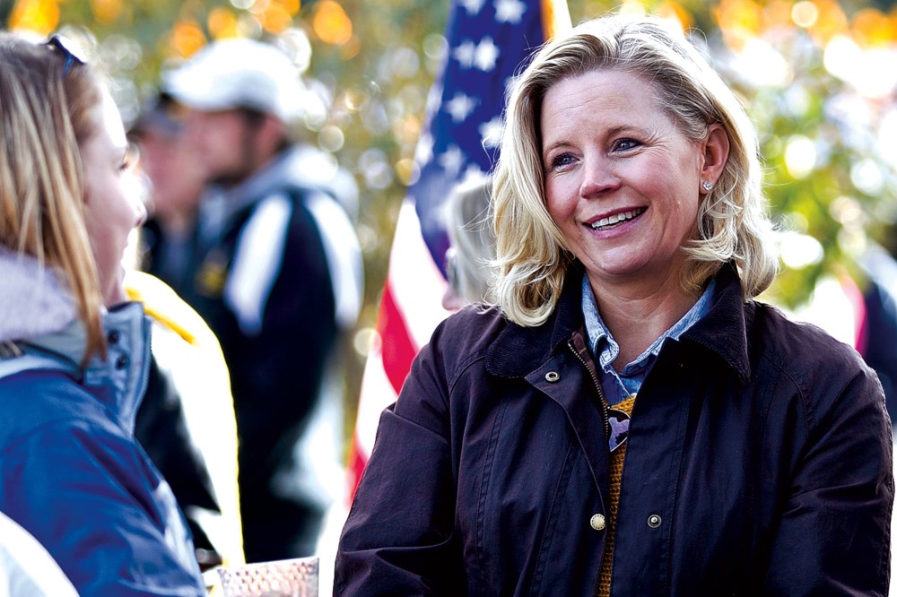 Liz Cheney talks with Laramie residents prior to the start of the University of Wyoming homecoming parade, Oct. 12, 2013.