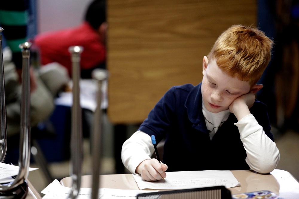 A second grader at George Buck Elementary School in Indianapolis, works on writing, March 25, 2014.