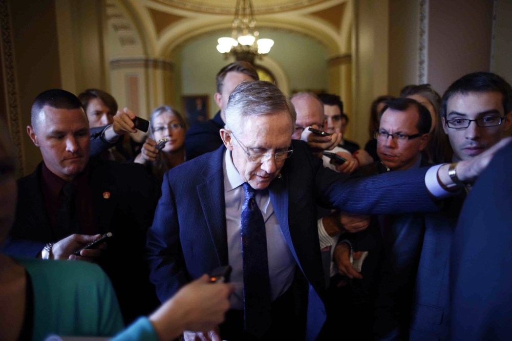 Senate Majority Leader Harry Reid of Nevada leaves the Senate floor to meet with Democratic Senators on Capitol Hill in Washington Saturday, Oct. 12, 2013.