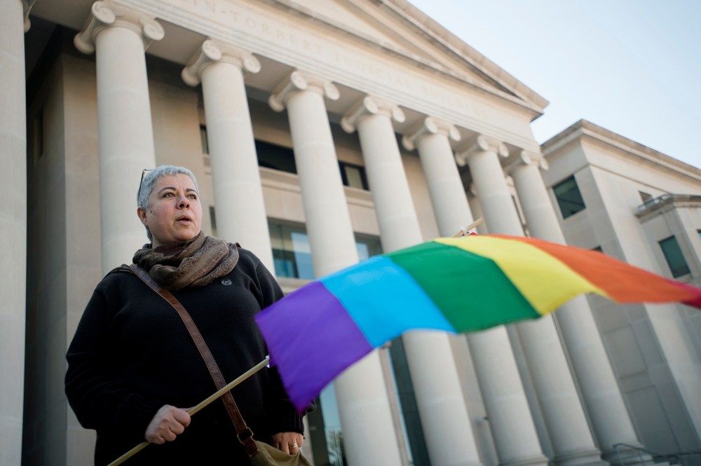 Minoo Vafai holds a rainbow flag during a rally against Alabama Chief Justice Roy Moore, Jan. 12, 2016, outside the Alabama Supreme Court building in Montgomery, Ala. (Photo by Albert Cesare/The Montgomery Advertiser/AP)