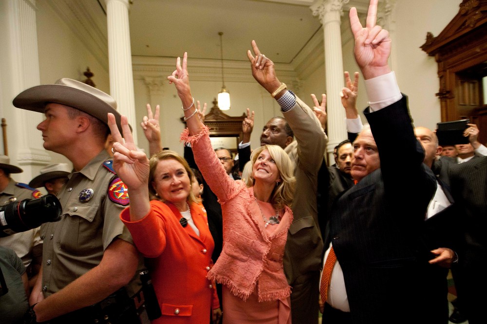 State Senators, from second left, Sylvia R. Garcia, D-Houston, Wendy Davis, D-Fort Worth, Royce West, D-Dallas, Kirk Watson, D-Austin, and John Whitmire, D-Houston,  greet abortion rights advocates to show they voted against HB2, which the Senate approved