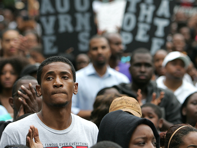 Protesters march and hold signs in the No Justice No Peace- "March Against Gun Violence" walk from Lake Eola in downtown Orlando, to the Orange County Courthouse on Wednesday, July 17, 2013. (Photo by Alex Menendez/AP)