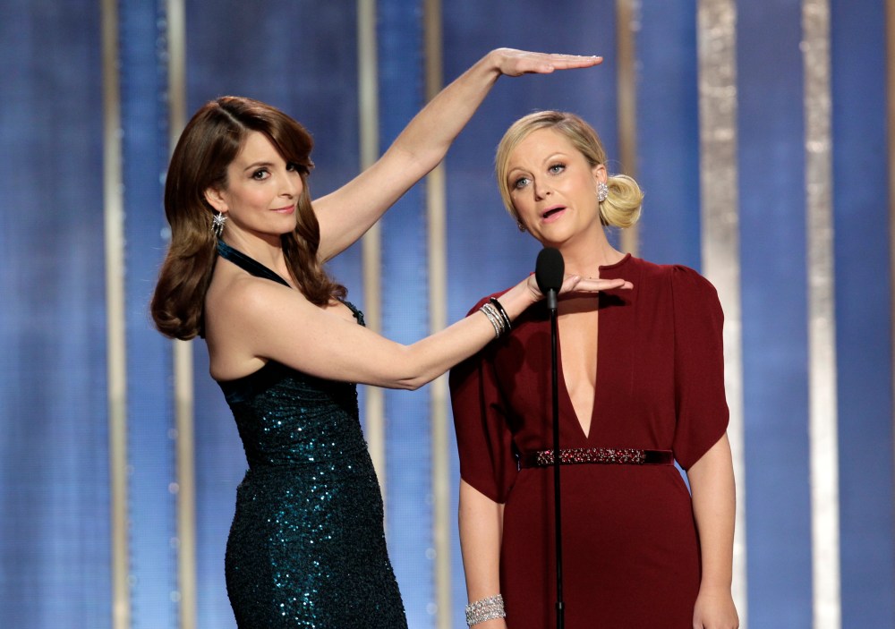 Comedians Tina Fey, left, and Amy Poehler during their opening monologue at the 70th annual Golden Globes Sunday night. (AP Photo/NBC, Paul Drinkwater)