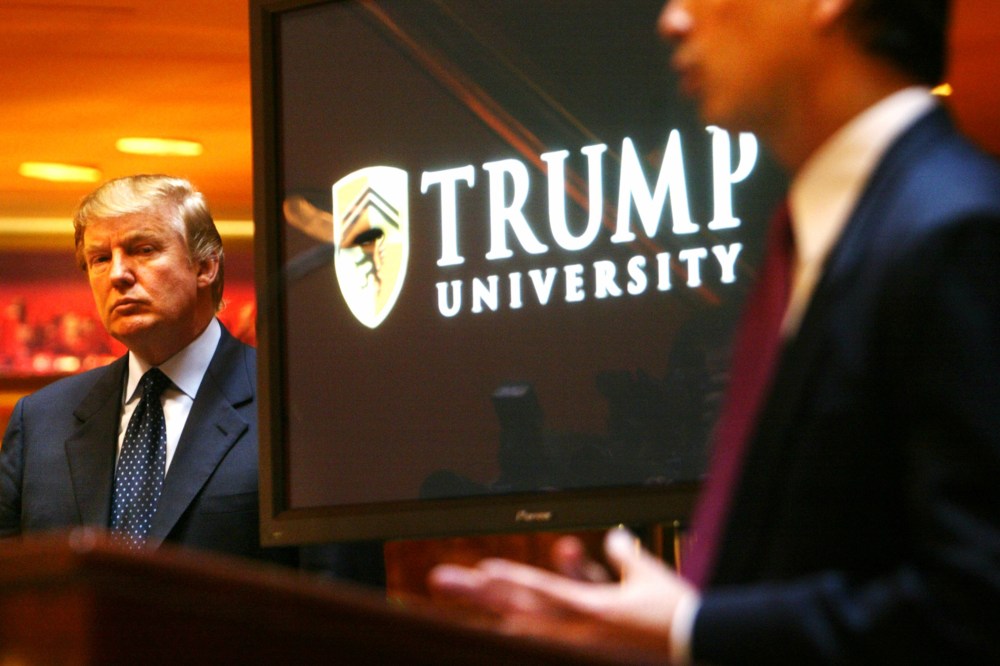 Real estate mogul and TV star Donald Trump listens as Michael Sexton introduces him to announce the establishment of Trump University at a press conference in New York, May 23, 2005. (Photo by Bebeto Matthews/AP)