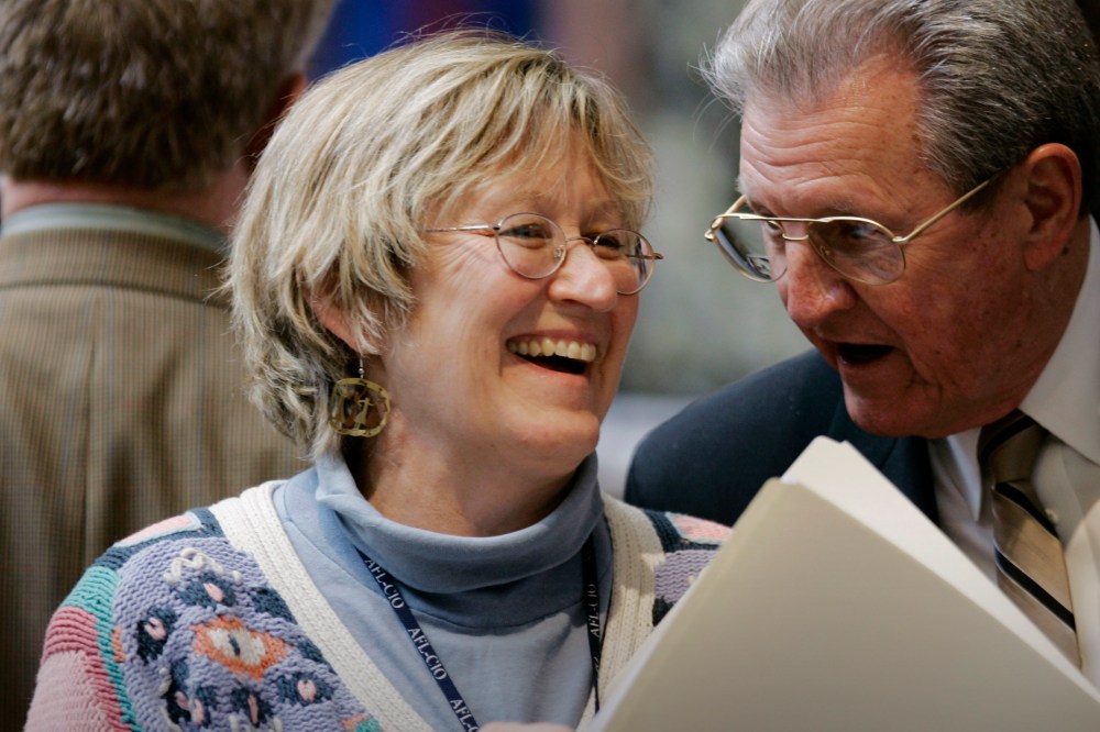Democratic Rep. Mary Lou Marzian of Louisville shares a light moment with a fellow Representative on the House floor in Frankfort, Ky., March 3, 2009. (Photo by Ed Reinke/AP)