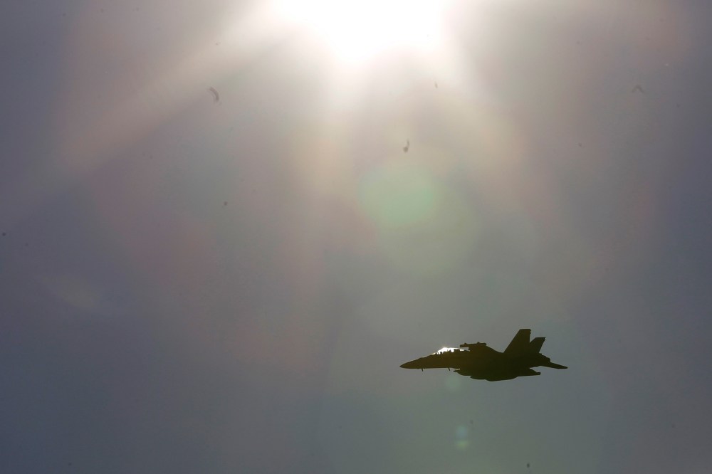 Pictured, an F-18 jet fighter jet. (Photo by Luca Bruno/AP)