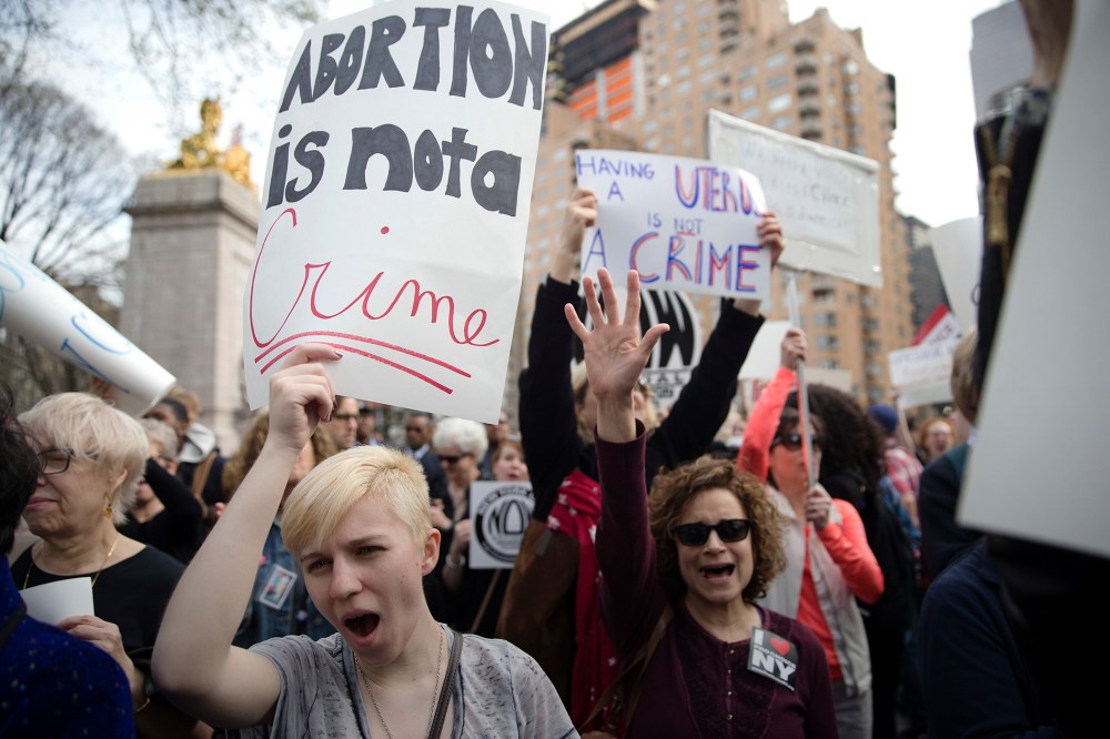 Kayla Forshey, left, participates in a rally to condemn Republican presidential candidate Donald Trump's remarks about women and abortion, March 31, 2016, in New York. (Photo by Mary Altaffer/AP)