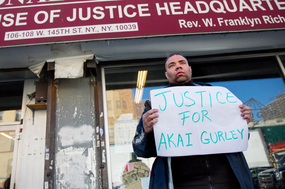 A man stands in front of the National Action Network on Nov. 22, 2014 in N.Y. after Rev. Al Sharpton spoke about the shooting of Akai Gurley. (Photo by Craig Ruttle/AP)
