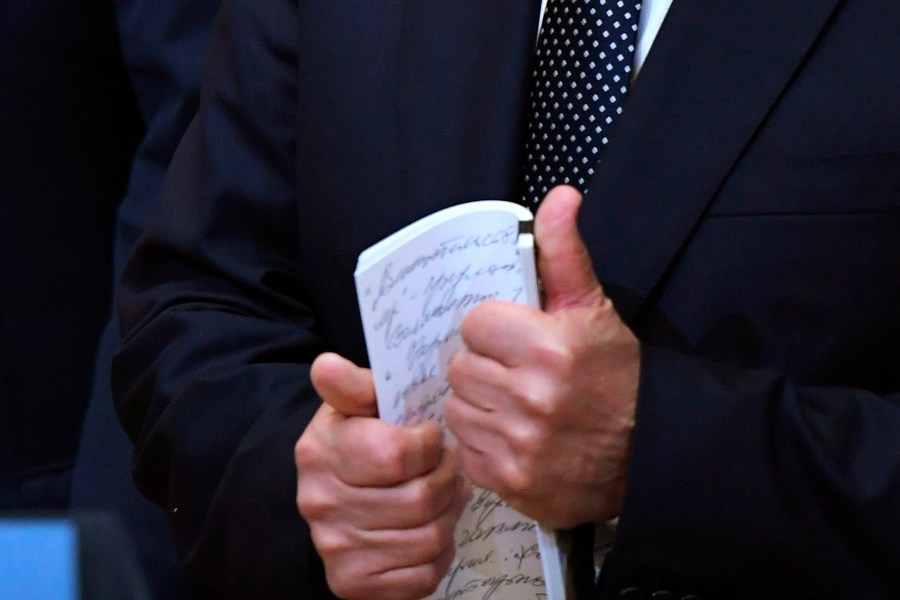 A cropped version of a photo of Russian President Vladimir Putin holding notes at a press conference after meeting with Donald Trump in the Presidential Palace in Helsinki, Finland, July 16, 2018.
