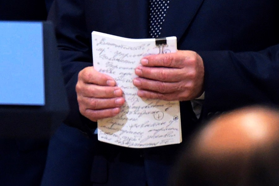 A cropped version of a photo of Russian President Vladimir Putin holding notes at a press conference after meeting with Donald Trump in the Presidential Palace in Helsinki, Finland, July 16, 2018.