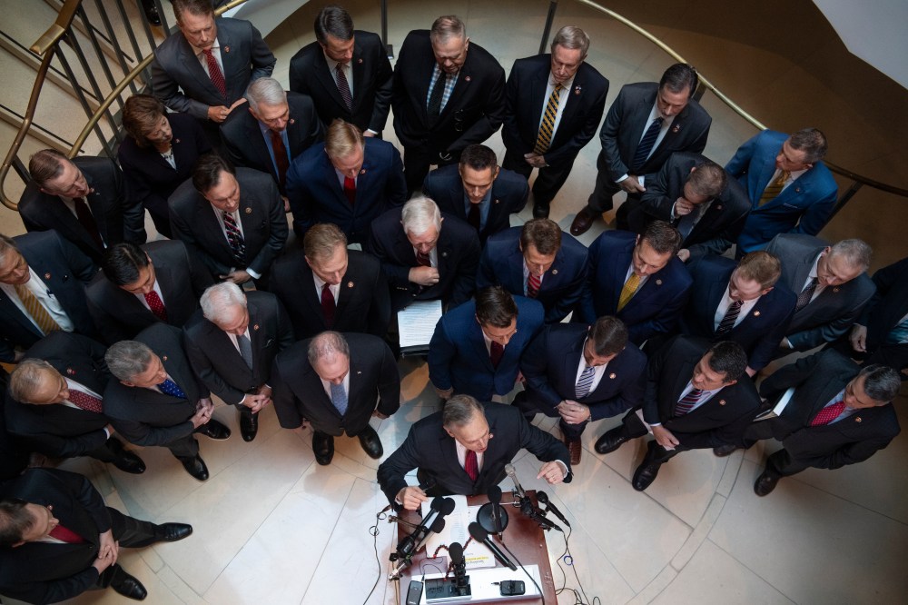 Rep. Andy Biggs, R-Ariz., at podium, speaks during a news conference in the Capitol Visitor Center outside the Laura Cooper, deputy assistant secretary of defense, deposition related to the House's impeachment inquiry on Wednesday, October 23, 2019.