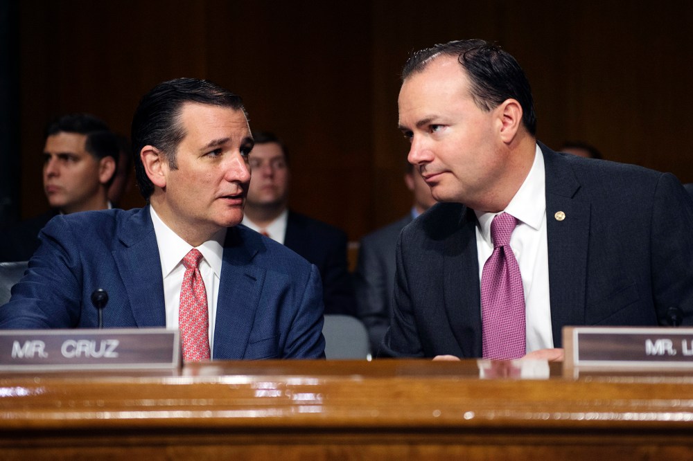 Sen. Ted Cruz, R-Texas, and Sen. Mike Lee, R-Utah, confer before a Senate Judiciary hearing to examine the Administration's immigration enforcement policies, in Washington, July 21, 2015. (Photo by Molly Riley/AP)