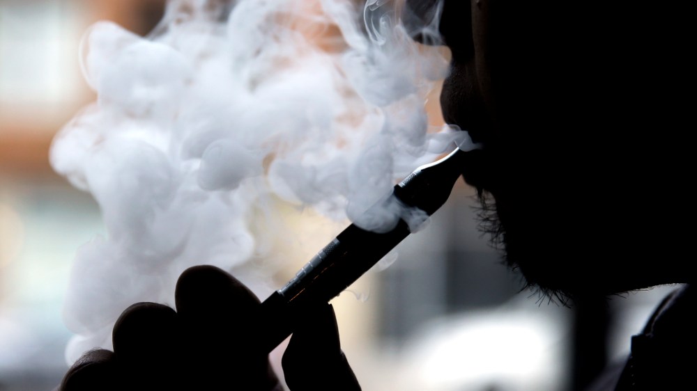 In this April 23, 2014, file photo, a man smokes an e-cigarette at Vape store in Chicago. (Photo by Nam Y. Huh/AP)