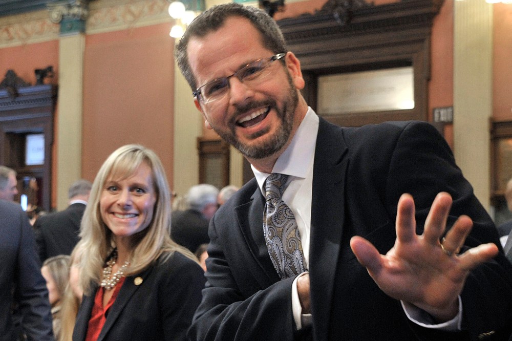In this Jan. 14, 2015 photo, Rep. Cindy Gamrat, R-Plainwell, and Rep Todd Courser, R-Lapeer wave to reporters in the House of Representatives in Lansing. (Photo by Dale G. Young/Detroit News/AP)