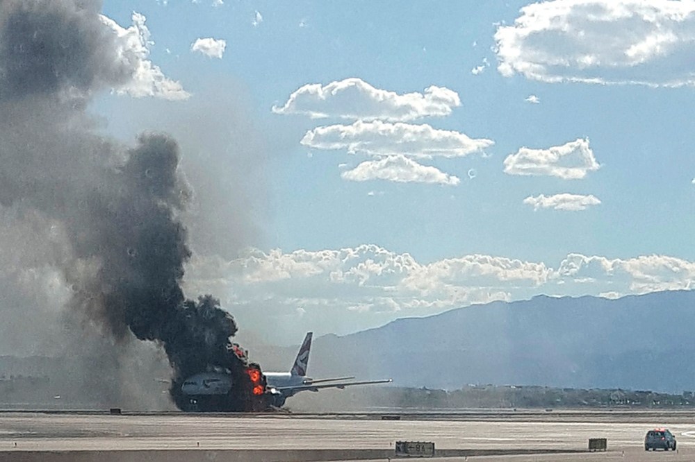 Smoke billows out from a plane that caught fire at McCarren International Airport on Sept. 8, 2015, in Las Vegas, Nev. (Photo by Eric Hays/AP)