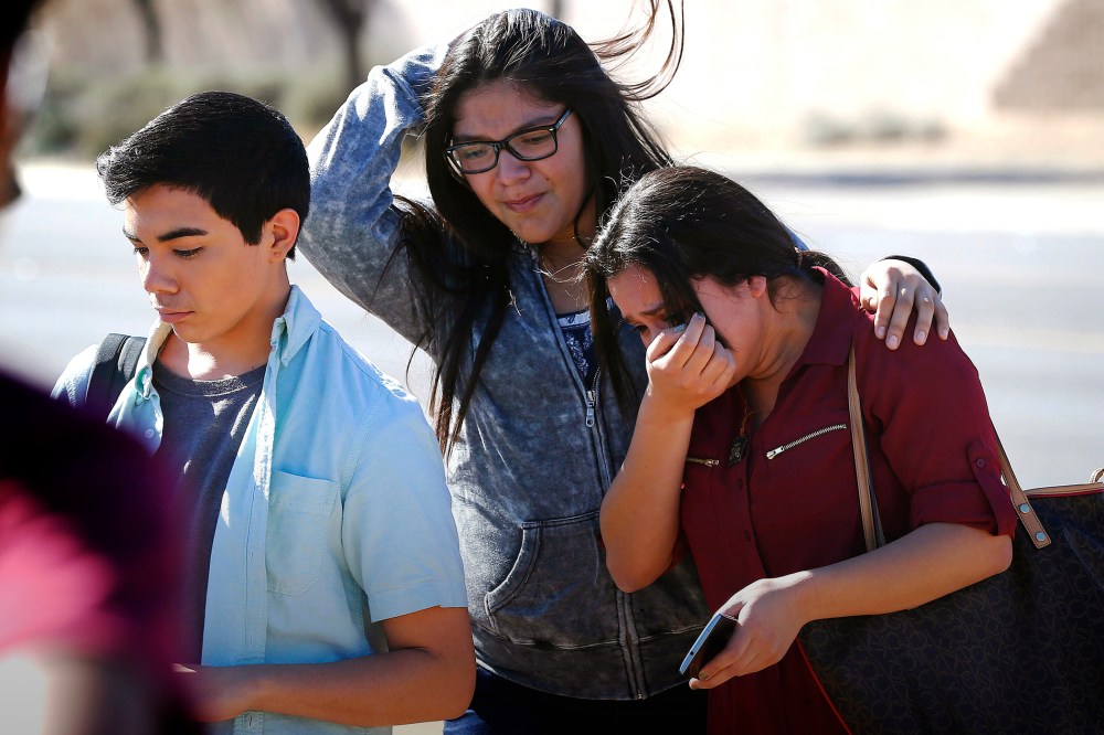 Students walk to their parents after being released from lockdown, Feb. 12, 2016, in Glendale, Ariz., after two students were shot and killed at Independence High School. (Photo by Matt York/AP)