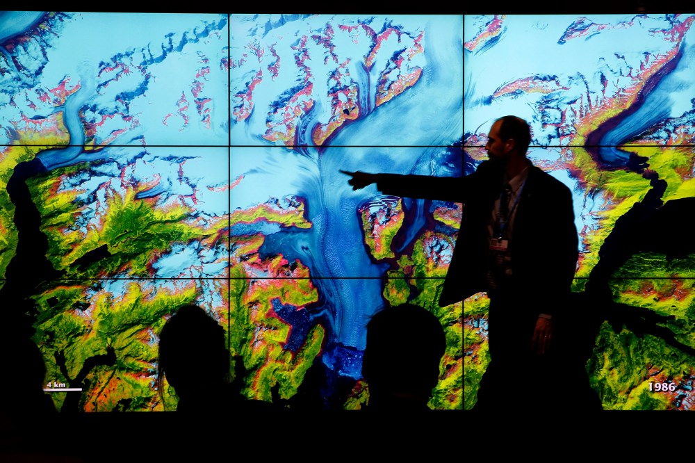People attend a climate conference at the U.S. pavilion during the COP21, United Nations Climate Change Conference in Le Bourget, north of Paris, Dec. 10, 2015. (Photo by Christophe Ena/AP)