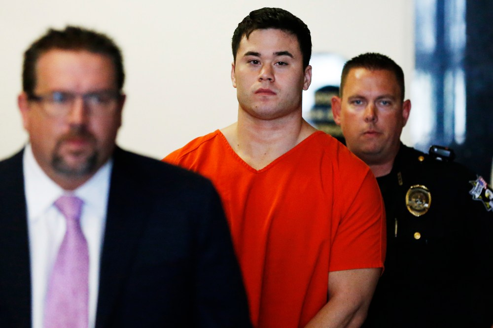 In this Sept. 3, 2014, file photo Daniel Holtzclaw, center, arrives for a hearing in Oklahoma City. (Photo by Sue Ogrocki/AP)