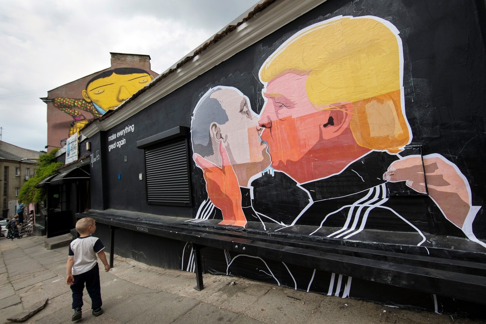 A child walks past a graffiti depicting Russian President Vladimir Putin and Republican presidential candidate Donald Trump on the walls of a bar in the old town in Vilnius, Lithuania, May 14, 2016. (Photo by Mindaugas Kulbis/AP)
