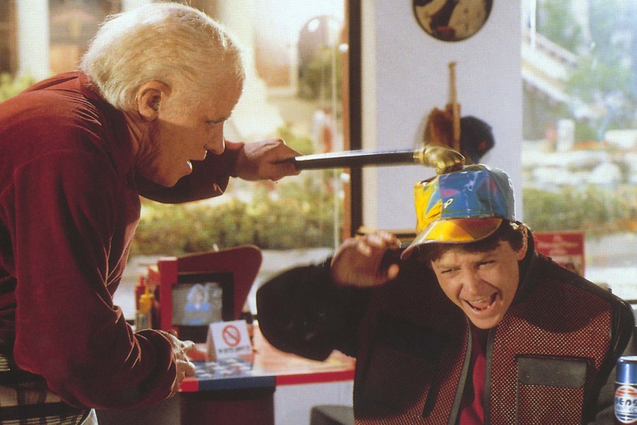 Thomas F. Wilson as Biff Tannen and Michael J. Fox as Marty McFly in 