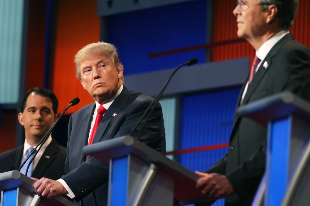 Republican presidential candidate Donald Trump looks toward Jeb Bush, right, as Scott Walker watches during the first Republican presidential debate at the Quicken Loans Arena on Aug. 6, 2015, in Cleveland, Ohio. (Photo by Andrew Harnik/AP)