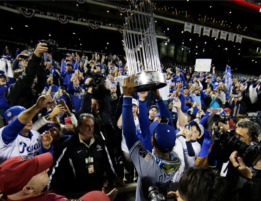 Kansas City Royals' Jarrod Dyson holds the World Series trophy after Game 5 of the Major League Baseball World Series against the New York Mets, Nov. 2, 2015, in New York, N.Y. (Photo by Matt Slocum/AP)